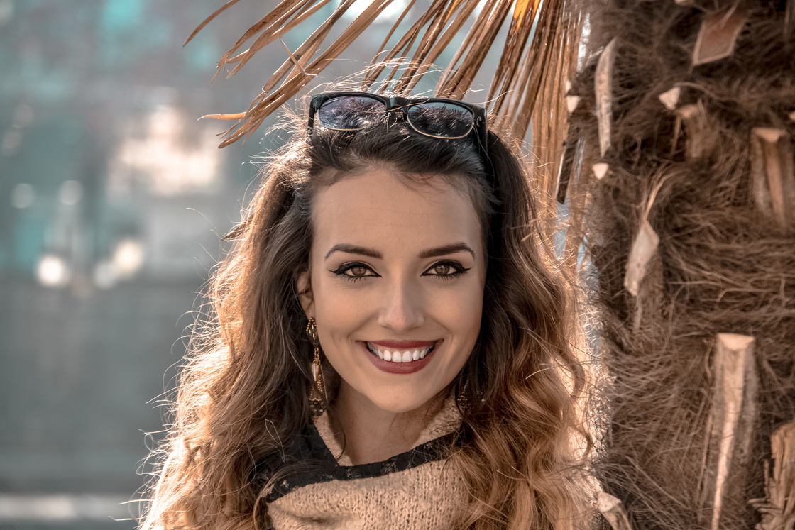 Smiling Woman beside Coconut Tree